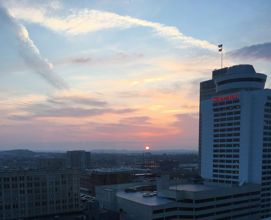 Sunset over Nashville, mountains in distance, looking out 20th floor past Sheraton hotel.
